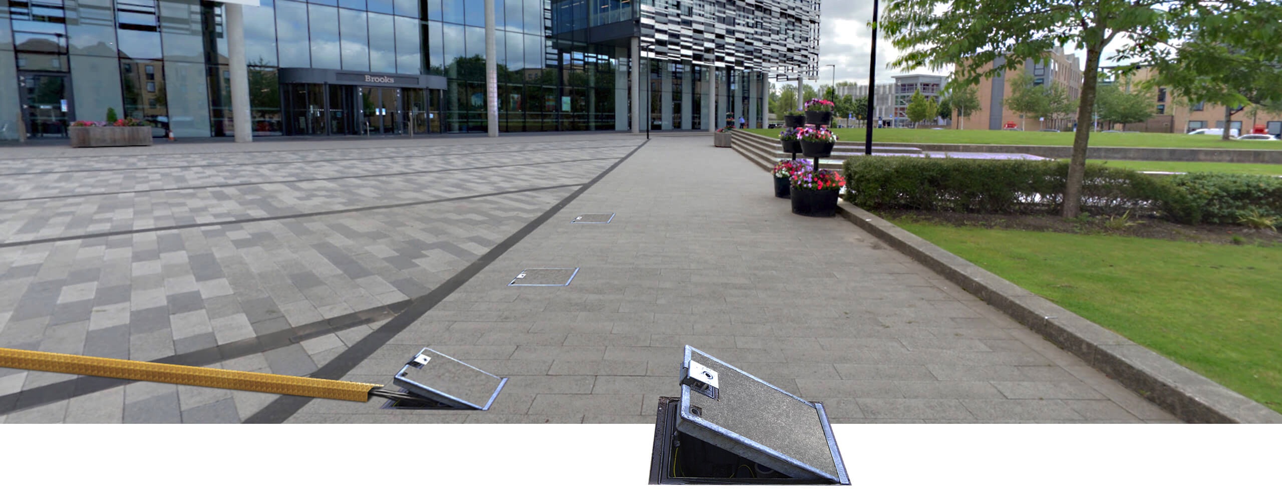 Pop Up Power Supplies in-ground units outside a university campus building